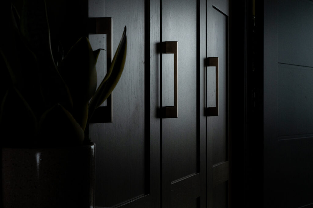 Dramatic lighting on dark cabinets